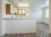 Thumbnail 6 of 34 - an empty kitchen with a counter top and a refrigerator