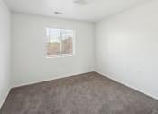 Thumbnail 16 of 34 - an empty room with carpet and a window