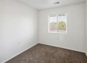 Thumbnail 15 of 34 - an empty room with carpet and a window