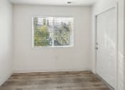 Thumbnail 11 of 34 - an empty room with a window and a door
