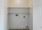 Thumbnail 19 of 34 - a room with white walls and a white shelf and a door