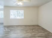 Thumbnail 12 of 34 - an empty living room with white walls and a window