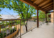 Thumbnail 3 of 24 - A balcony with a metal railing and a concrete floor.