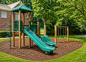 Thumbnail 5 of 13 - Playground area with slides and swings at Stratford Arms Apartments, Riverdale