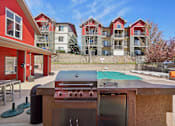 Thumbnail 23 of 36 - A red and white building with a pool table and a grill in front.