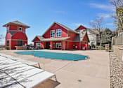 Thumbnail 22 of 36 - A red house with a pool in the backyard.