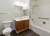 Thumbnail 5 of 22 - A white toilet sits next to a sink in a bathroom.