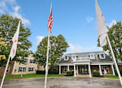 Thumbnail 18 of 22 - A building with a flag in front of it.