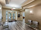Thumbnail 14 of 22 - A waiting room with chairs and a wall-mounted light fixture.