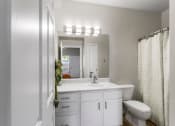 Thumbnail 16 of 30 - a bathroom with a sink toilet and a mirror