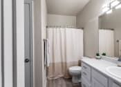 Thumbnail 17 of 30 - a bathroom with a shower and a toilet and a sink