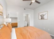 Thumbnail 10 of 30 - a bedroom with a bed and a ceiling fan