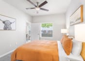 Thumbnail 8 of 30 - a bedroom with a bed and a ceiling fan