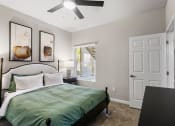 Thumbnail 13 of 30 - a bedroom with a bed and a ceiling fan