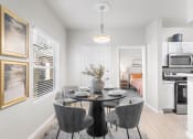 Thumbnail 4 of 30 - a dining room with a table and chairs