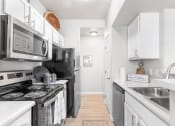 Thumbnail 7 of 30 - a kitchen with stainless steel appliances and white cabinets