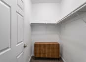 Thumbnail 12 of 30 - a walk in closet with a wooden crate in the middle of it