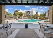Thumbnail 45 of 56 - our apartments have a pool and patio with chairs and tables at Vista Linda, Santa Fe, NM 87507