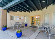 Thumbnail 42 of 56 - a patio with tables and chairs outside of a building at Vista Linda, Santa Fe