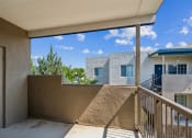 Thumbnail 38 of 56 - a balcony with a view of a building and a blue sky at Vista Linda, Santa Fe, NM 87507