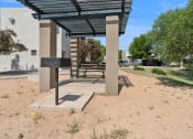 Thumbnail 34 of 56 - a picnic pavilion with a bench in front of a building at Vista Linda, Santa Fe, New Mexico