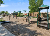 Thumbnail 30 of 56 - a playground with a swing set and other playground equipment at Vista Linda, New Mexico 87507