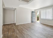 Thumbnail 6 of 56 - the living room and dining room of an apartment with wood flooring at Vista Linda, Santa Fe