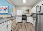 Thumbnail 55 of 56 - a kitchen with stainless steel appliances and white cabinets at Vista Linda, New Mexico