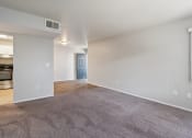 Thumbnail 17 of 56 - the living room and dining room of an apartment with carpeting and a kitchen at Vista Linda, Santa Fe