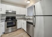 Thumbnail 2 of 56 - a kitchen with stainless steel appliances and white cabinets at Vista Linda, Santa Fe, NM 87507