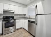 Thumbnail 1 of 56 - a kitchen with stainless steel appliances and white cabinets at Vista Linda, New Mexico