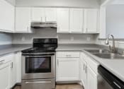 Thumbnail 3 of 56 - a kitchen with white cabinets and stainless steel appliances at Vista Linda, Santa Fe