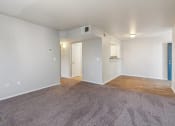 Thumbnail 19 of 56 - an empty living room with a wood floor and white walls at Vista Linda, Santa Fe, 87507