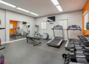 Thumbnail 47 of 56 - A gym with orange walls and a variety of equipment. at Vista Linda, Santa Fe, NM