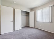 Thumbnail 20 of 56 - an empty bedroom with a closet and a window at Vista Linda, New Mexico 87507
