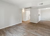 Thumbnail 9 of 56 - the living room and dining room in a new home with white walls and wood floors at Vista Linda, Santa Fe