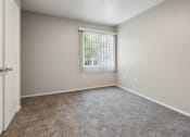 Thumbnail 12 of 56 - an empty room with carpet and a window at Vista Linda, Santa Fe