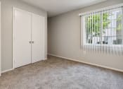 Thumbnail 11 of 56 - an empty bedroom with a window and a closet at Vista Linda, Santa Fe, NM