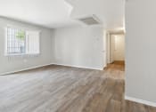 Thumbnail 7 of 56 - the living room and dining room of an apartment with wood flooring at Vista Linda, Santa Fe, New Mexico