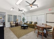 Thumbnail 5 of 16 - an open living room and dining room with a table and ceiling fans