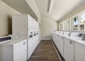 Thumbnail 11 of 16 - the preserve at ballantyne commons community laundry room with washes and dryers