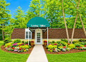 Thumbnail 1 of 9 - A green Leasing Office building with a white walkway leading to the entrance.