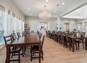 Thumbnail 19 of 26 - a large dining room with long tables and chairs and a chandelier