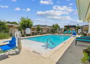 Thumbnail 11 of 26 - our apartments have a swimming pool with blue chairs