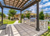 Thumbnail 13 of 26 - the preserve at ballantyne commons clubhouse with a grill and a patio with benches