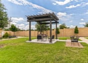 Thumbnail 12 of 26 - a patio with a picnic table and a gazebo