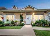 Thumbnail 15 of 26 - a house with a white door and a sidewalk in front of it