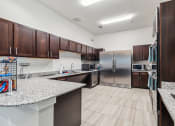 Thumbnail 16 of 26 - full kitchen with stainless steel appliances and granite counter tops at the reserve at south coast