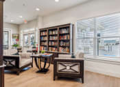 Thumbnail 21 of 26 - a living room with couches and chairs and a bookshelf filled with books