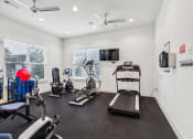 Thumbnail 9 of 26 - the gym with treadmills and exercise equipment at 1861 muleshoe road apartments